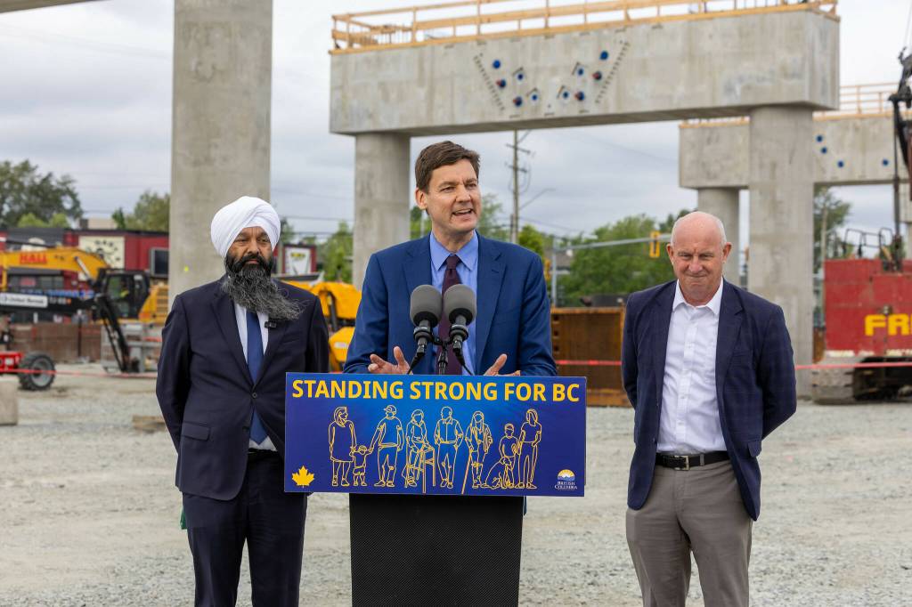 Image 3: Premier David Eby, at microphone, was joined by Surrey Centre MP Randeep Sarai and B.C. Minister of Transportation and Transit Mike Farnworth at a May 8 event marking the progress of the Surrey Langley SkyTrain project, at the site of the future Willowbrook station on the Langley-Surrey border. (B.C. Government/Flickr)