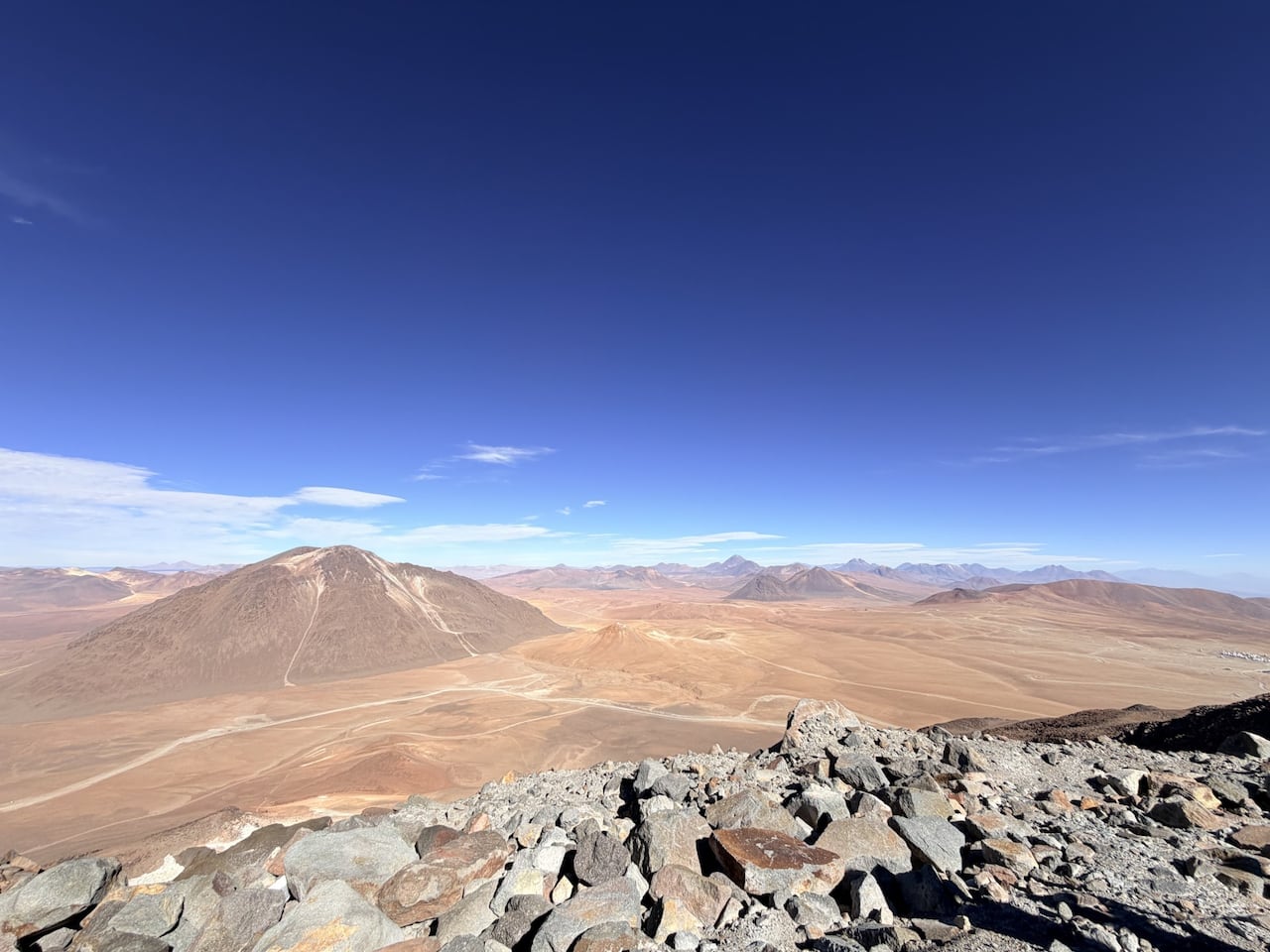 Image 5: A view of a desert and mountains under a blue sky.