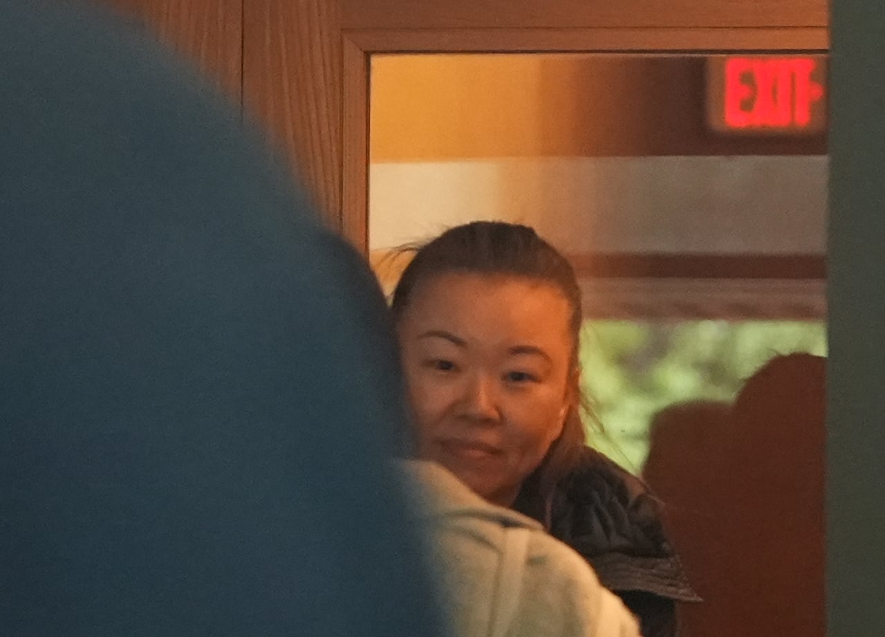 Image 5: Helen Chan Sun peers outside shortly before entering the courtroom where she will be sent to jail for civil contempt. The 49-year-old began serving a 40-day sentence Friday.