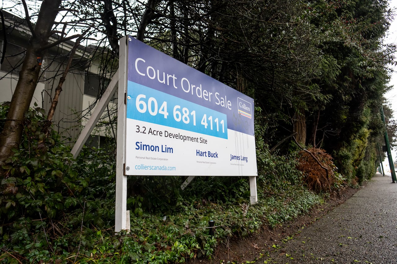 Image 6: A real estate billboard advertising a court-ordered sale is posted at a condo building