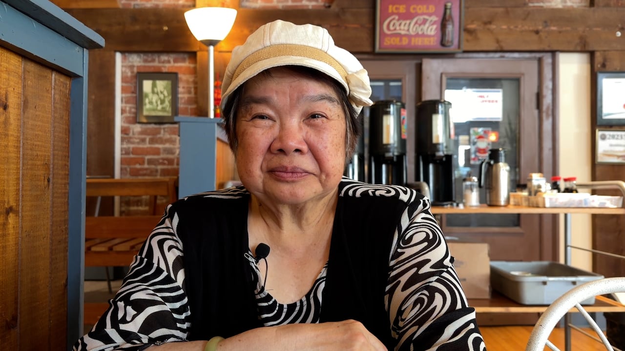 Image 5: chinese elder sitting at a table